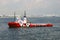 Red and white Tug boat in Singapore anchorage.