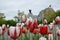 Red and white tulip flowers and statue in Ottawa, Canada