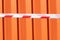 red and white warning caution tape on an orange background. Danger unsafe area warning do not enter. Concept of no entry. Copy