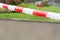 Red and white warning or cordon tape to stop pedestrians during rain