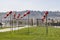 Red and white weather vane against a clear blue sky on a spring day. A large number of cones of wind indicators installed on the l