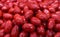Red whole Cerignola olives in oil close up