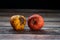 Red wilted rotten apple on a table. Bacteria infected rotten fruit