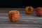 Red wilted rotten apples on a table. Bacteria infected rotten fruit