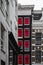 Red windows in Amsterdam on a narrow facade