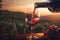 Red wine being poured into a glass from a bottle at sunset with a vineyard view, Generative AI 9