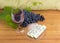 Red wine and blue cheese against of the blue grapes