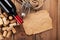 Red wine bottle, corks and corkscrew over wooden table background