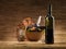 Red wine bottle, glass, grapes, wicker background