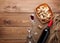 Red wine bottle, wine glass, bowl with corks and corkscrew