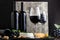 Red wine in classic glass with wine bottles composition. Elegant Wine bar menu with snacks cheese on dark moody