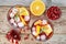 Red wine cranberry citrus pomegranate sangria. Top view, rustic wooden background.