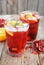 Red wine cranberry citrus pomegranate sangria. Top view, rustic wooden background.