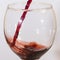 Red wine flow into glass macro