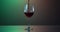 Red wine forms beautiful wave. Wine pouring in wine glass at dramatic background. Close-up shot. Slow motion of pouring