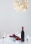 Red wine with fruits on a table, and beautiful chandelier