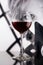 Red wine glass against black and white girl poster
