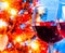 Red wine glass against blur lights tree background