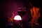 Red wine glass with light in the background and fire on the side in purple color