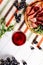 Red wine glass with sliced jamon plate on table background. Top close-up view copy space