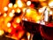 Red wine glasses against colorful unfocused lights background