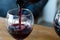 Red wine is poured into a glass - the concept of drunkenness and alcoholism.