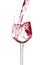 Red wine is pouring into a glass goblet on a white background.