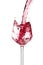 Red wine is pouring into a glass goblet on a white background.