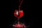 Red wine pouring into a glass splashing