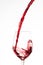Red wine pouring in a wine glass, on a white background