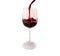 Red wine pours into a tall glass