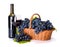Red wine and ripe blue grape in basket