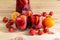 Red wine sangria with fruits in glasses and pitcher and fresh fruits near. Selective focus