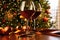 Red wine on table with Christmas tree