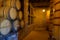 Red wine tasting in an old wine cellar with wooden wine barrels in a winery, Soft focus effect