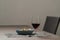 Red wine in thin wine glass with pasta in blue bowl