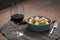 Red wine in thin wine glass with salad in blue bowl