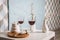 Red wine , wine glass, corkscrew. white table, decoration corner . at home. Restaurant