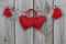 Red and wood country hearts hanging on clothesline with wooden background