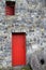 Red wood door and window in gorgeous stone building