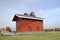 Red wood slatted corn crib