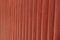 Red wooden background of painted pine logs