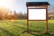 Red wooden billboard with clean white space for text in a park on green grass