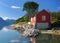 Red Wooden Boat House On The Shore Of The Lustrafjord In Hoyheimsvik