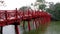 Red wooden bridge by the blue lake