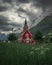 Red wooden church of Olden in the Nordfjord fjord in summer in Norway