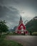 Red wooden church of Olden in the Nordfjord fjord in summer in Norway