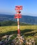 Red, wooden crossroads signpost on Dry mountain