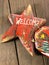 Red wooden decoration comet star shaped on wooden background
