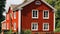 Red, wooden detached house. Nordic style, old, historical